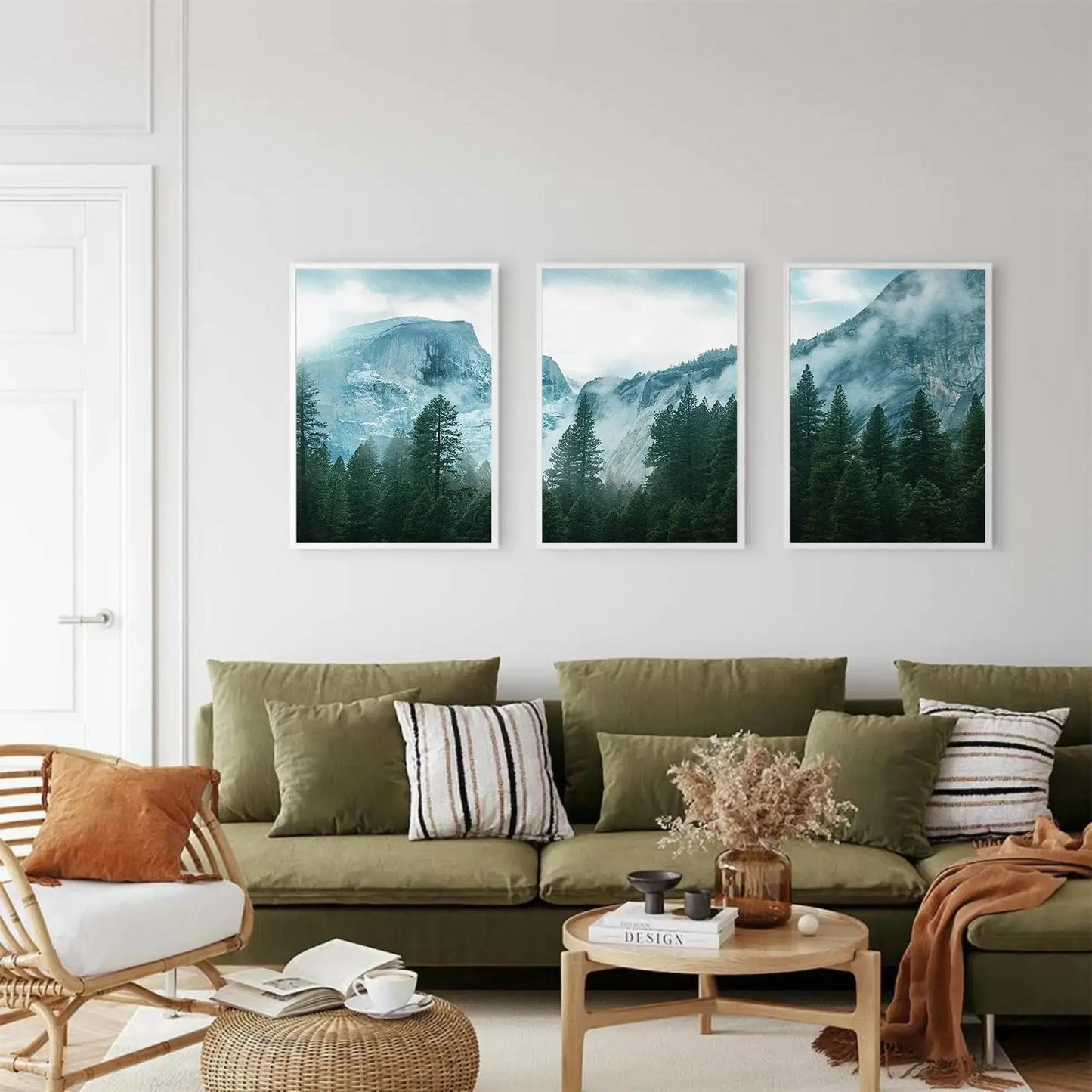 Living room with a green sofa, decorative pillows, and three mountain landscape paintings on the wall.