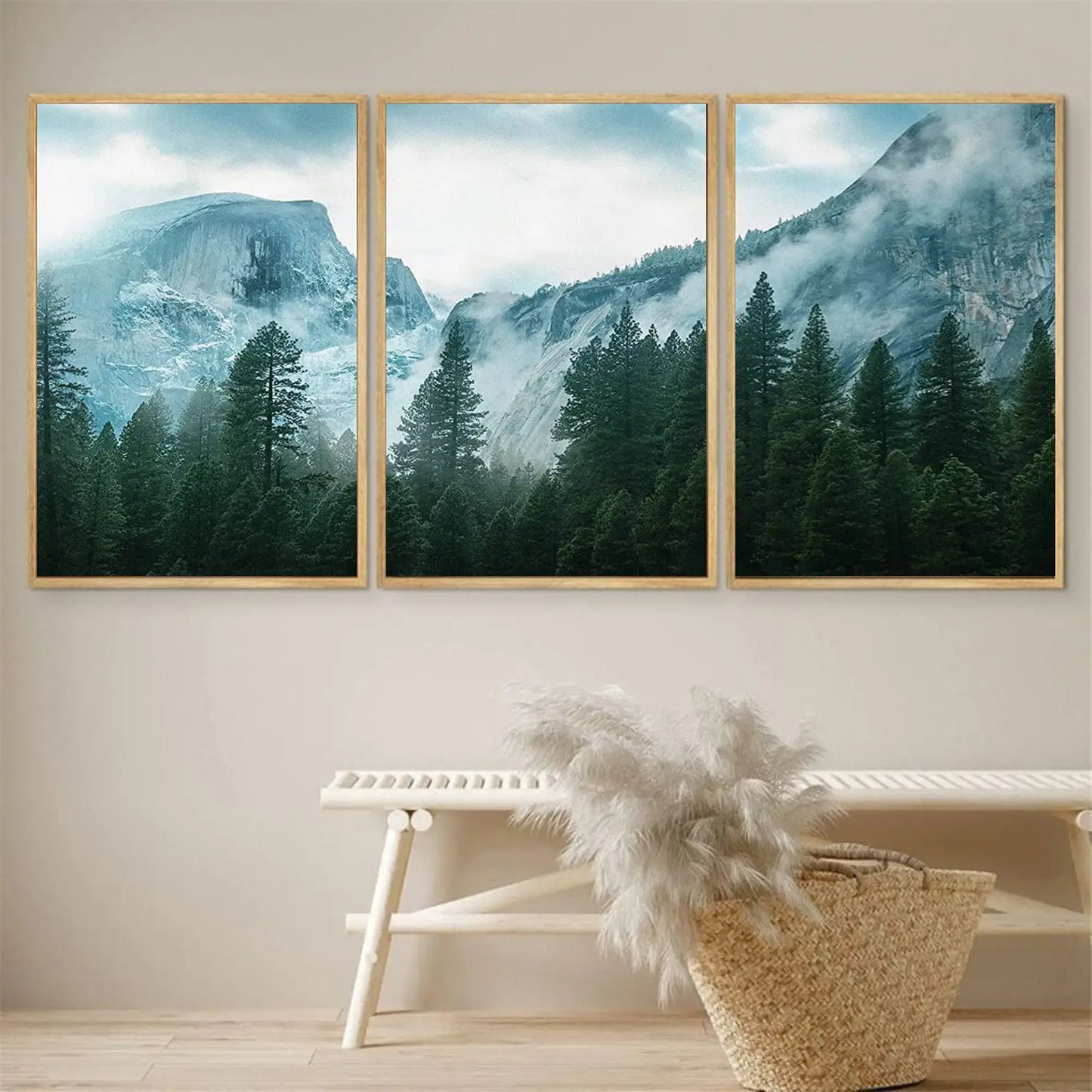 Three framed mountain landscape pictures on a wall above a bench with decorative items.