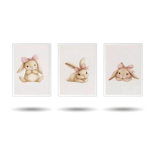 A set of three minimalist rabbit wall art prints for a baby nursery. The framed art features a seated bunny, a bunny with a flower, and a playful bunny on a white background.