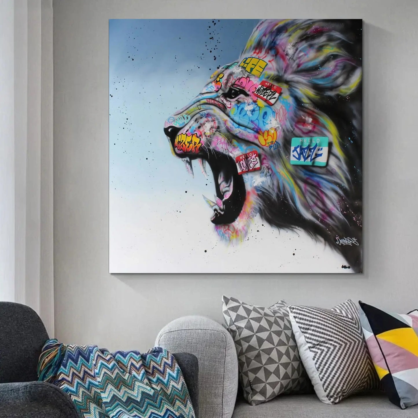 Colorful lion painting on a wall above a sofa with patterned cushions.