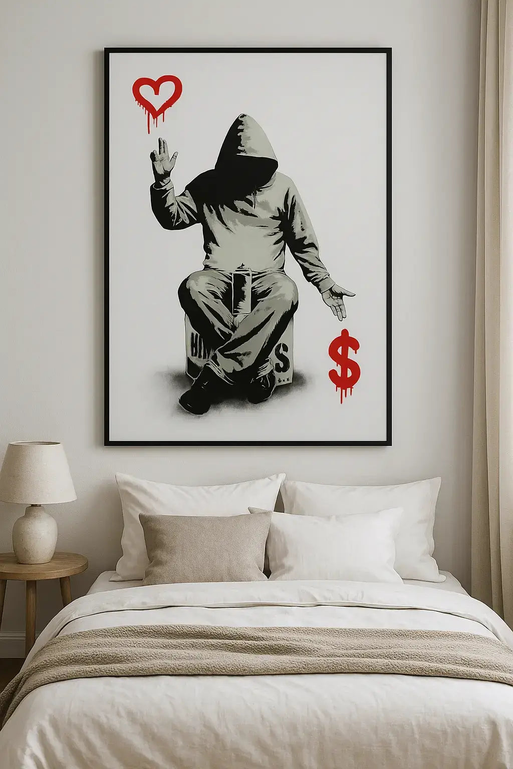 Framed artwork of a hooded figure with a heart and dollar sign on a wall above a bed.