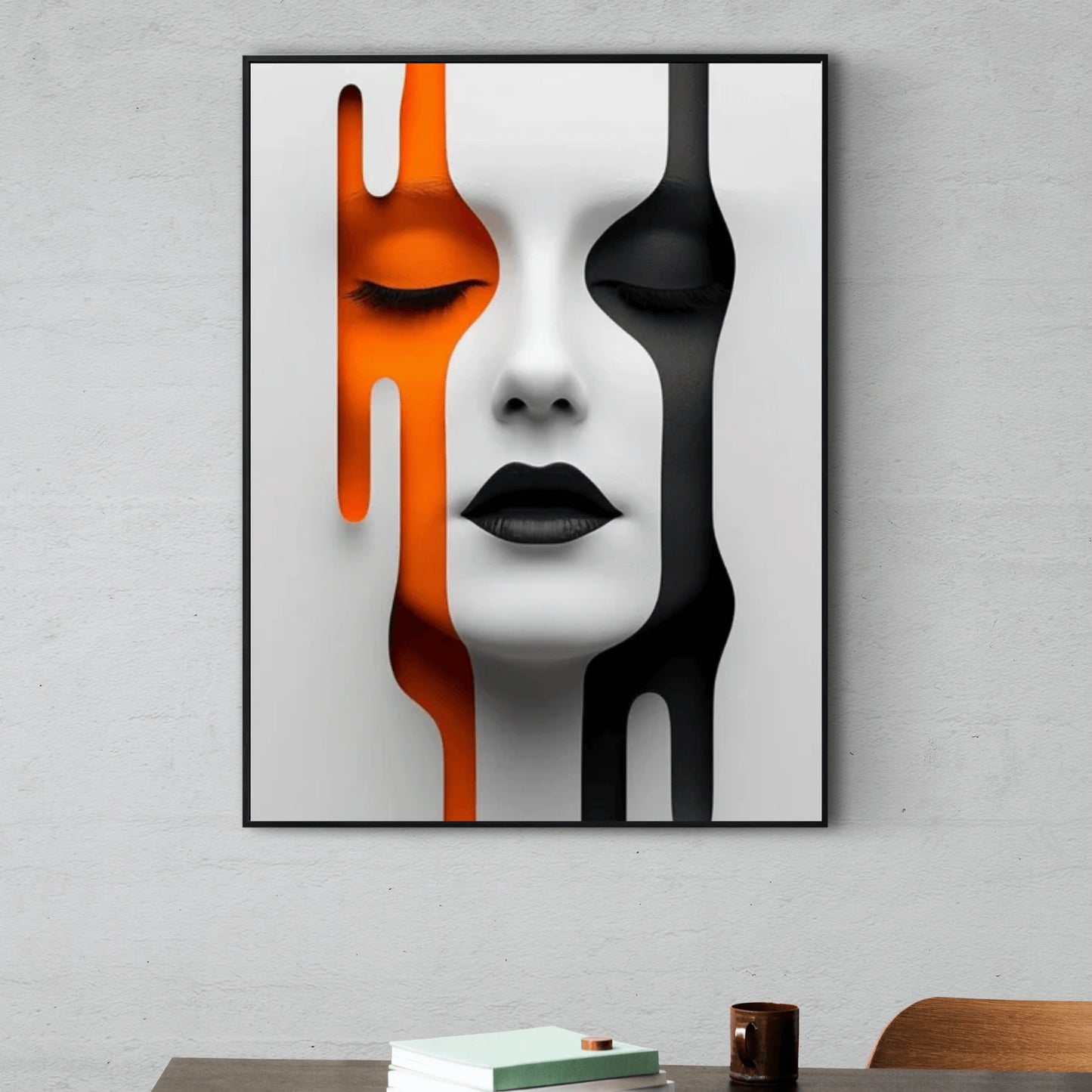 Abstract art print of a face with orange, black, and white colors on a gray wall.