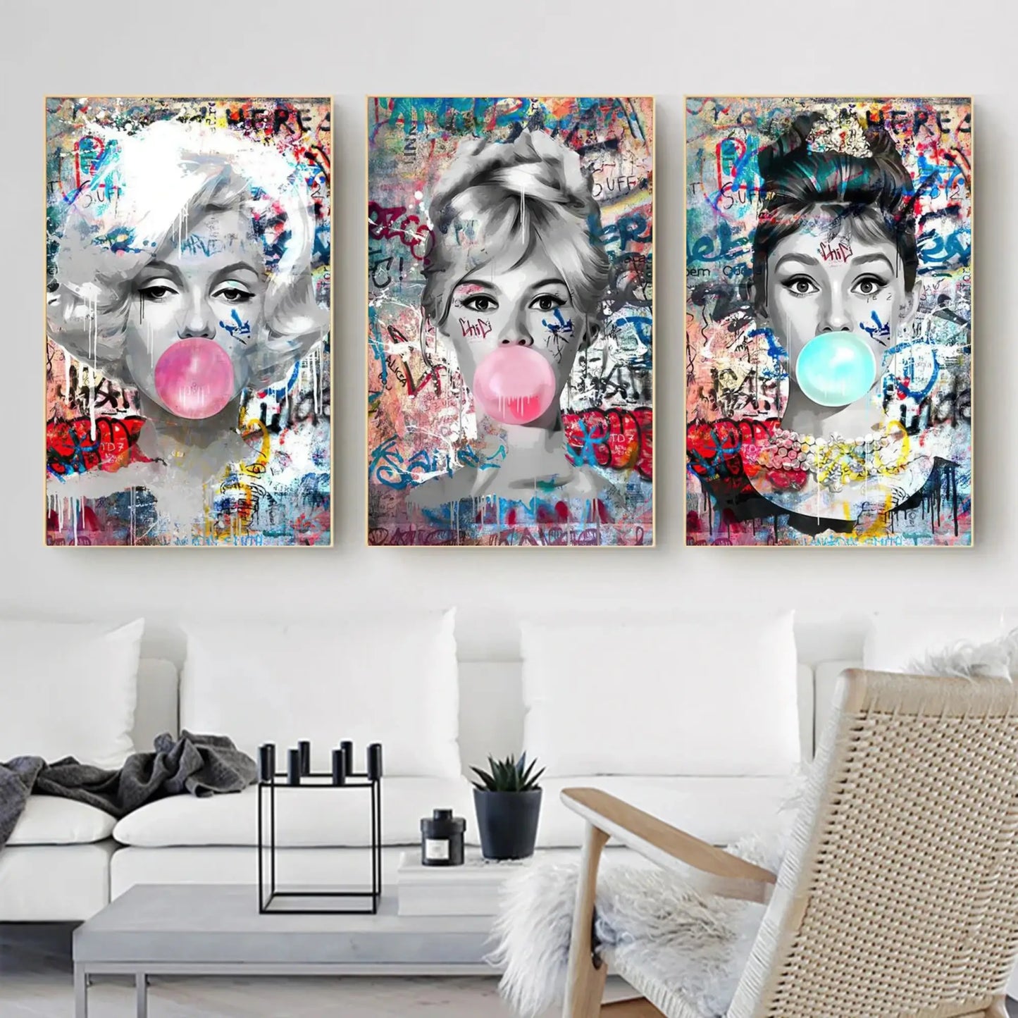 Three colorful art prints of a woman with a bubble gum bubble on a wall in a living room.
