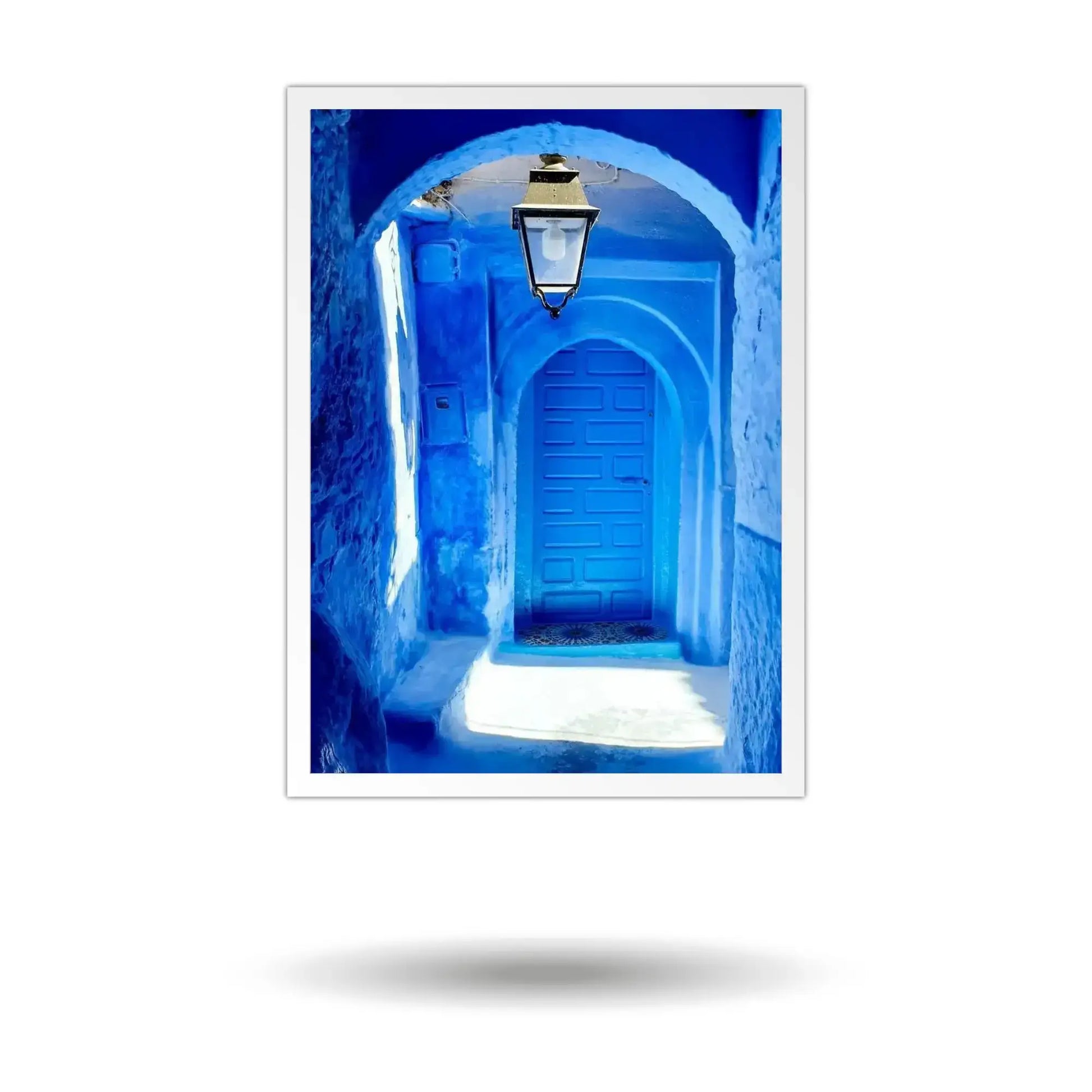 Framed photograph of a blue alleyway with a lantern in Chefchaouen, Morocco.