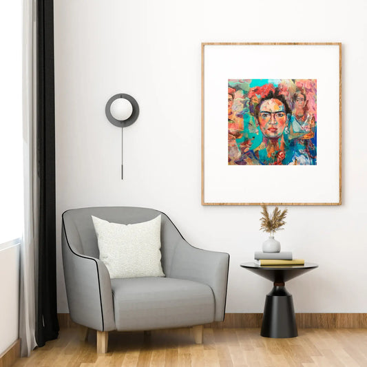 Modern living room with a gray armchair, side table, and colorful framed artwork on the wall.