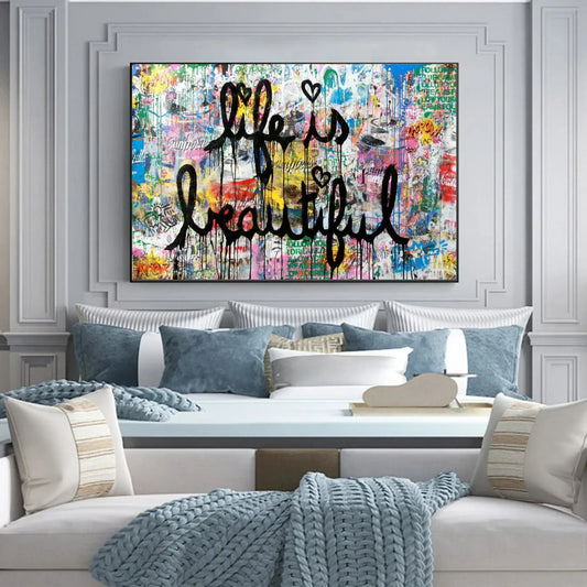 Colorful abstract painting with 'Life is Beautiful' text above a sofa in a living room.
