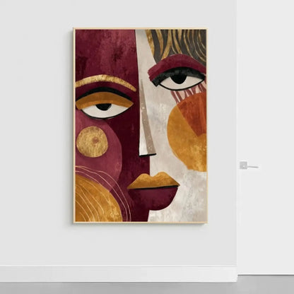 Modern abstract wall art featuring a split portrait of a face with cubist and boho influences. The left side is deep burgundy with a large stylized eye and gold geometric circles. The right side is warm beige with an eye, abstract gold and ochre shapes, and prominent gold lips. This luxury canvas print is ideal for contemporary living room wall decor.