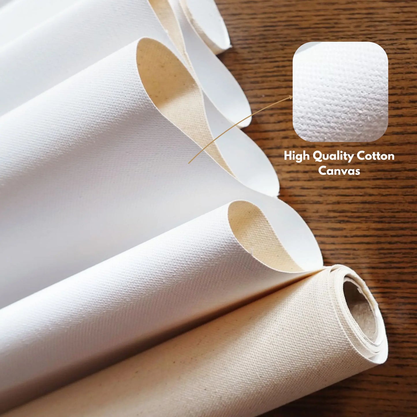 Rolls of high-quality cotton canvas on a wooden surface with a close-up of a square piece.