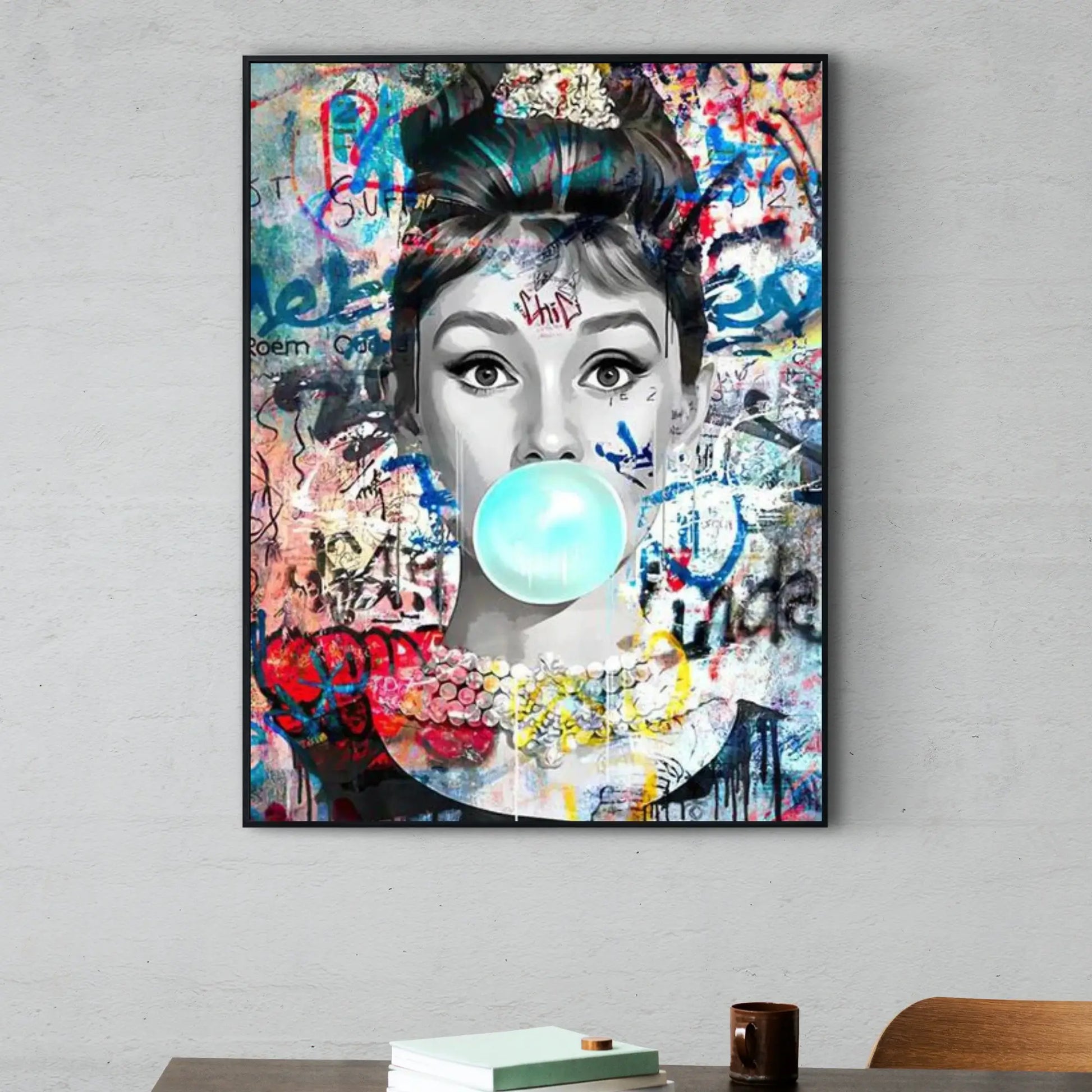 Framed artwork of a woman blowing a bubble with colorful graffiti-style background